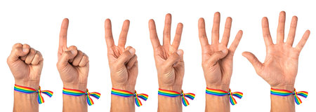 Man shows the numbers on his fingers, one, two, three, four, five. Pride male hand with rainbow LGBT...