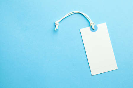 Tags for the price and labels for clothes. White tag mock-up on a blue background. Copy space for textの写真素材