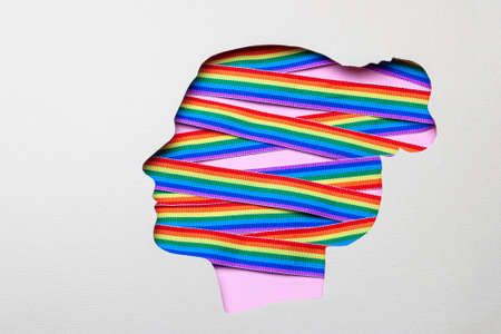 Silhouette of a female head and rainbow ribbons of LGBT pride. Lesbians in the head.の写真素材
