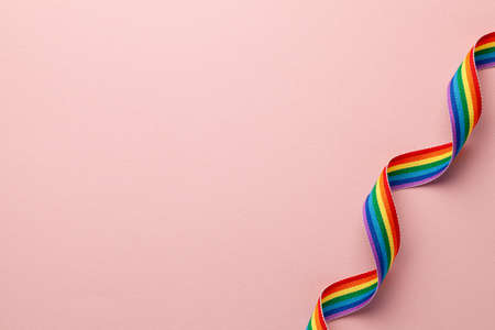 LGBT rainbow ribbon pride tape symbol. Pink background. Copy space for textの写真素材