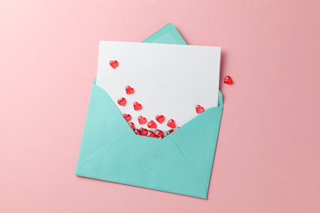 Love letter with red hearts. Blank template with place for text on postcard. Green envelope on pink...