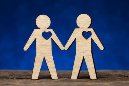 Gay couple. Two figures of men hold handsの写真素材