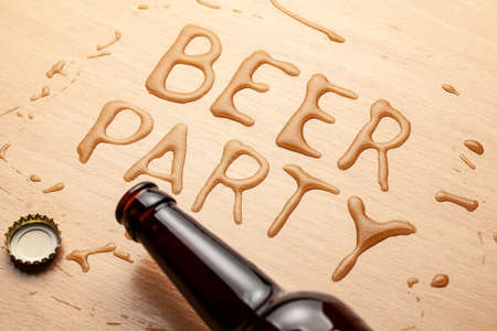 Beer party. A bottle of beer and a spilled drinkの写真素材