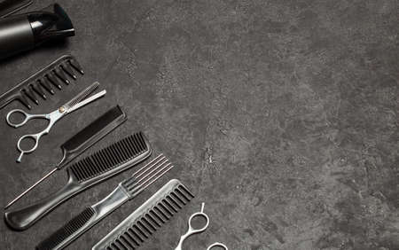 Black combs and combs with scissors on a black background. Copy space for text.の写真素材
