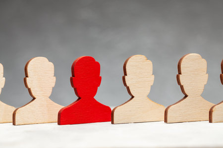 Staff recruitment. The figures of the workers are all the same and one in red. Leader Choice. HR....