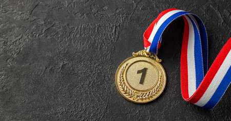 Gold medal with ribbons. Award for first place in the competition. Prize to the champion. Black backgroundの写真素材