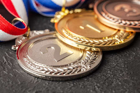 Gold, silver and bronze medal with ribbons. Award for first, second and third place in the competition. Prize to the champion. Black backgroundの写真素材