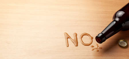 No alcohol. Beer bottle and spilled drink in the form of letters NO. Copy space for text.の写真素材