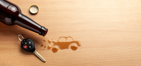 Drunk driving. Accident with a broken car from alcohol. Beer bottle and car keys. Broken carの写真素材