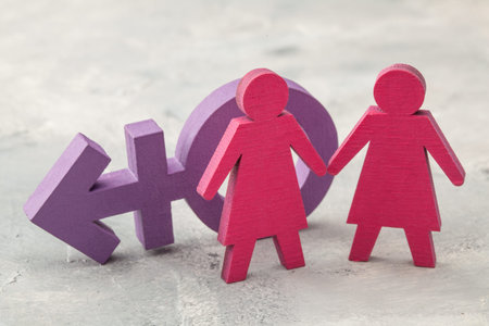 Couple of lesbians holding hands on transgender symbol backgroundの写真素材