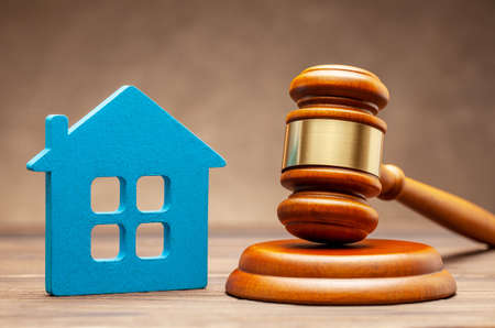 House and judge gavel on brown background. The concept of selling a home cher auction or property sectionの写真素材