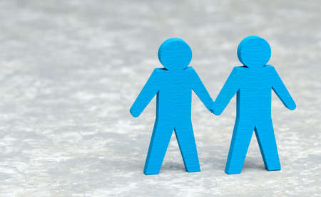 Two  men holding hands on grayの写真素材