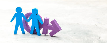 Gay couple holding hands on transgender symbol background