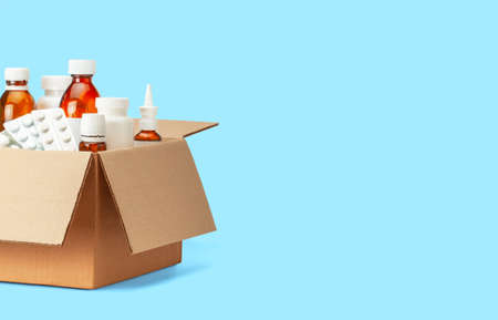Delivery of medicines home from the pharmacy. Cardboard box with medicines, pills, bottles, spraysの写真素材