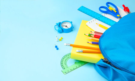 School bag. Backpack with supplies for school on blue. Copy space for text