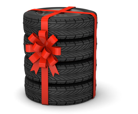 Tires as a gift. A set of four tires with disks tied with a red gift ribbon with a bow. isolated on white background. 3d renderの写真素材