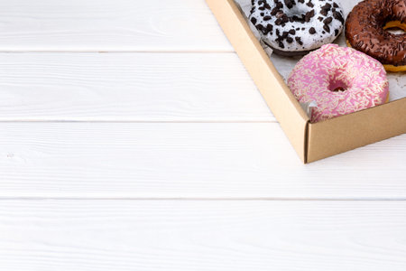 Donuts in a box on a white background. Template Copy space for text