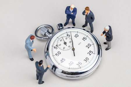 Stopwatch and businessmen in suits. Quick business meeting. Fast brainstormingの写真素材