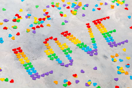 The word LOVE made of small hearts in the colors of the flag of the LGBT communityの写真素材