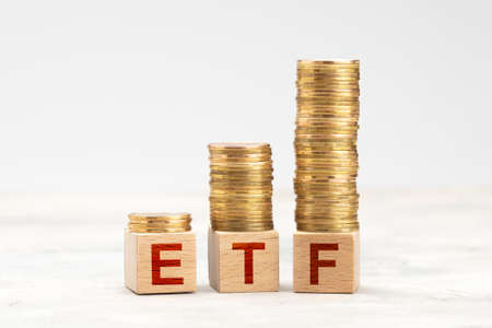 ETF fund. ETF management with stocks and bonds. Gold coins in pile as symbol of profitの写真素材
