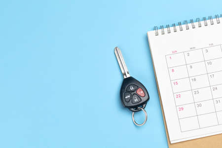 Car keys and calendar on a blue background. Template Copy space for textの写真素材