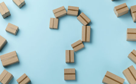 Question mark made from cardboard boxes on a blue background. Delivery choice conceptの写真素材