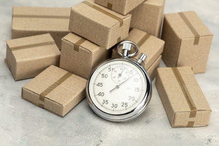 Stopwatch and cardboard boxes. Fast delivery conceptの写真素材