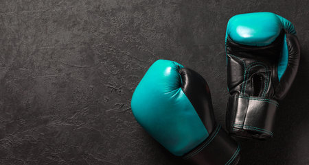 Green boxing gloves on a black background. Template Copy space for text. mock-upの写真素材