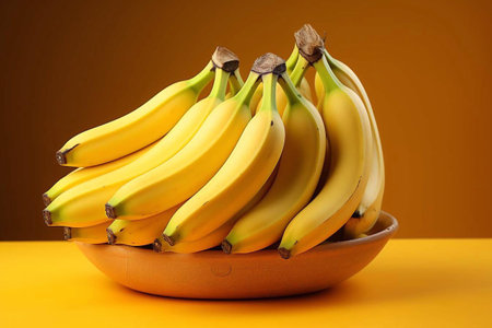 Bunch of bananas on a yellow background.の素材