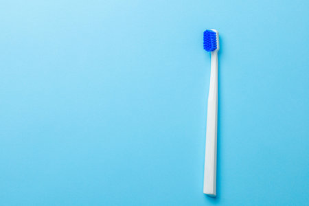 White toothbrush on blue background. Free space for text.の写真素材