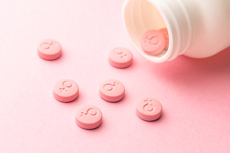 Female gender symbol on pink pills. Pills for women. Contraceptives or during menstruation.の写真素材