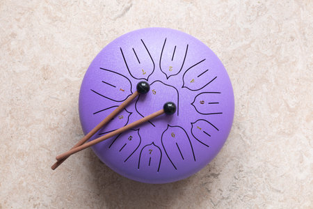 Tongue drum with drumsticks, Purple hang drum. music for relaxation and meditation.の写真素材