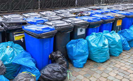 Black and blue trash cans and garbage bags.の写真素材