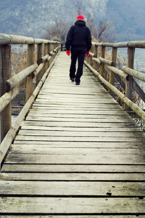 Man walking on the wooden bridgeの写真素材