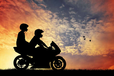 motorcyclist at sunsetの写真素材