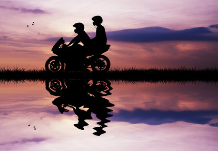 couple on a motorcycle at sunset