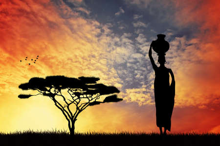 African woman carrying waterの写真素材