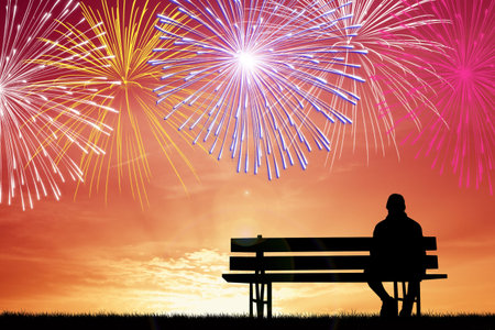man watching the fireworks on the benchの写真素材