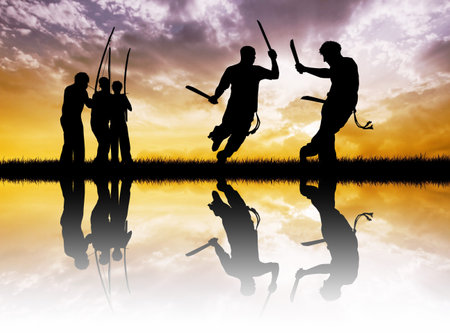 capoeira with swords at sunset
