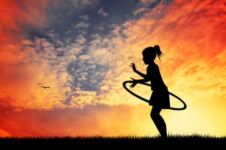 girl plays at sunsetの写真素材