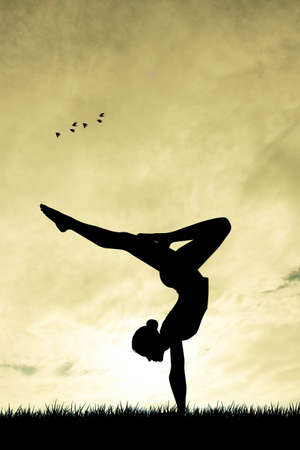 yoga silhouette at sunsetの写真素材