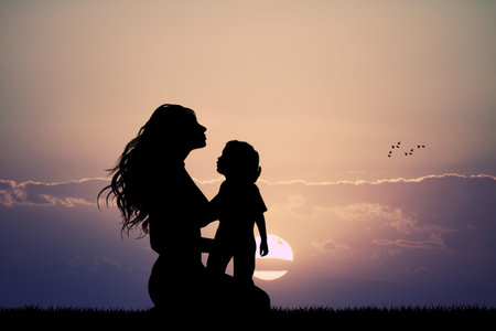 mother with son silhouette at sunsetの写真素材