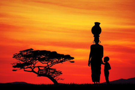 African woman with child in African landscapeの写真素材