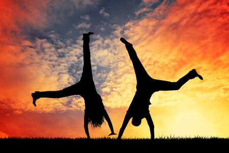 happy couple silhouette at sunsetの写真素材