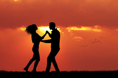 couple dancing at sunsetの写真素材