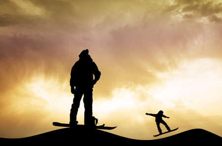 snowboarder silhouette at sunsetの写真素材
