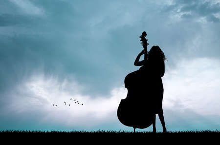 woman playing the cello at sunsetの写真素材