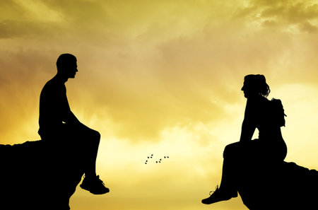 man and woman sitting on the summitの写真素材