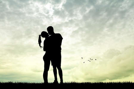 man and girl kissing at sunsetの写真素材