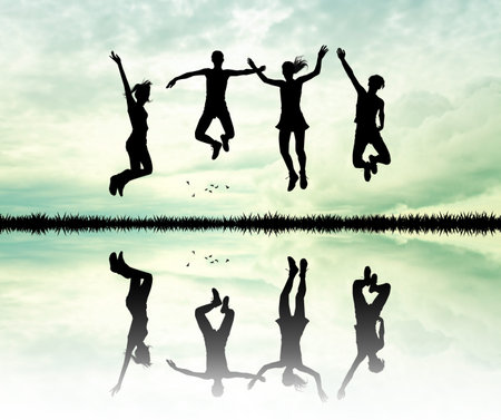 people jumping at sunsetの写真素材